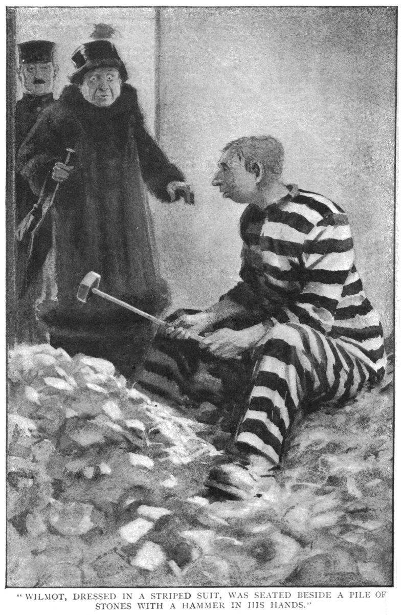 WILMOT, DRESSED IN A STRIPED SUIT, WAS SEATED BESIDE A PILE OF STONES WITH A HAMMER IN HIS HANDS.